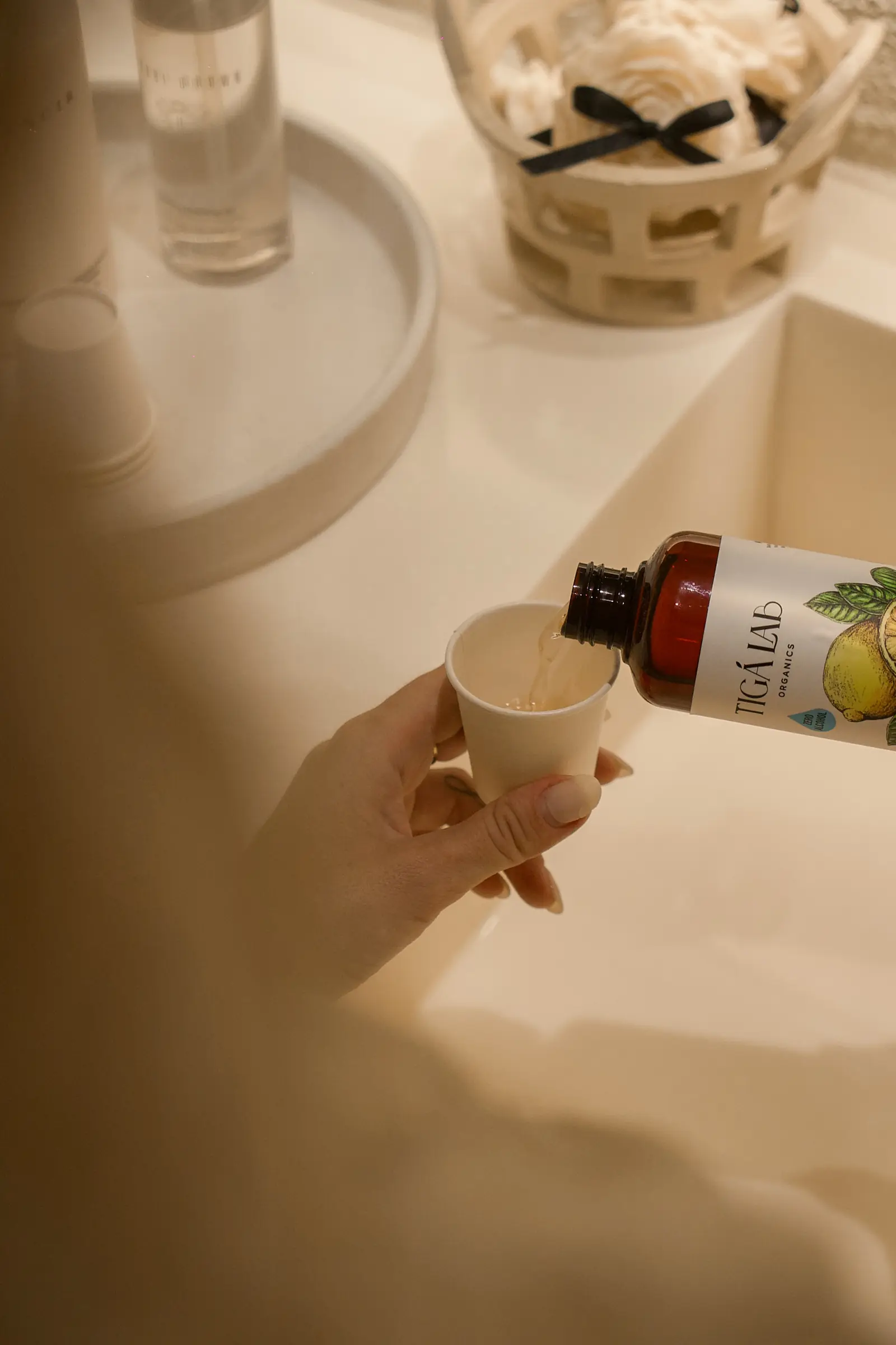 A guest pouring Tiga Lab mouthwash after the shower service