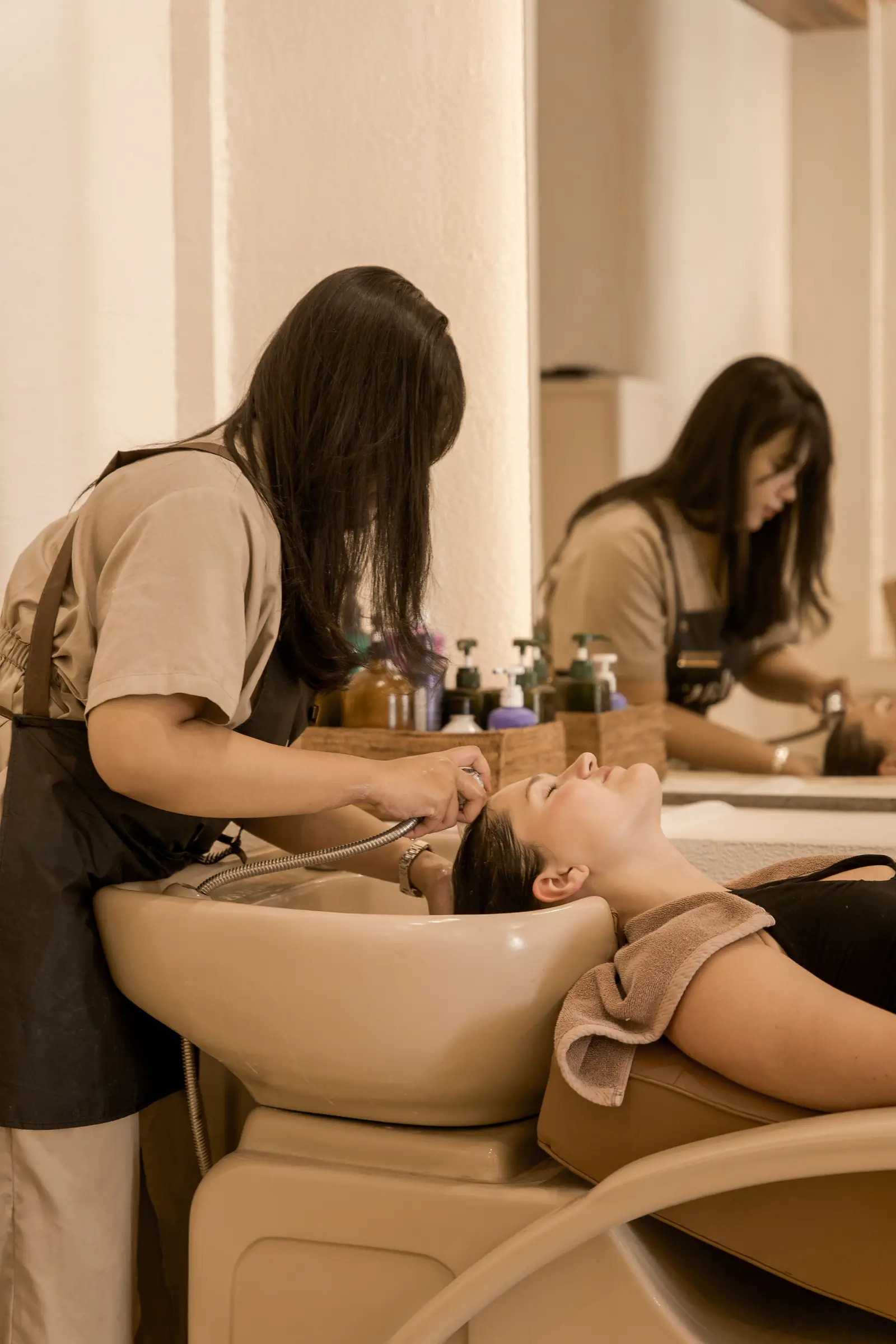 A guest having her hair washed at Day Hair Habit in Bali, looking relaxed
