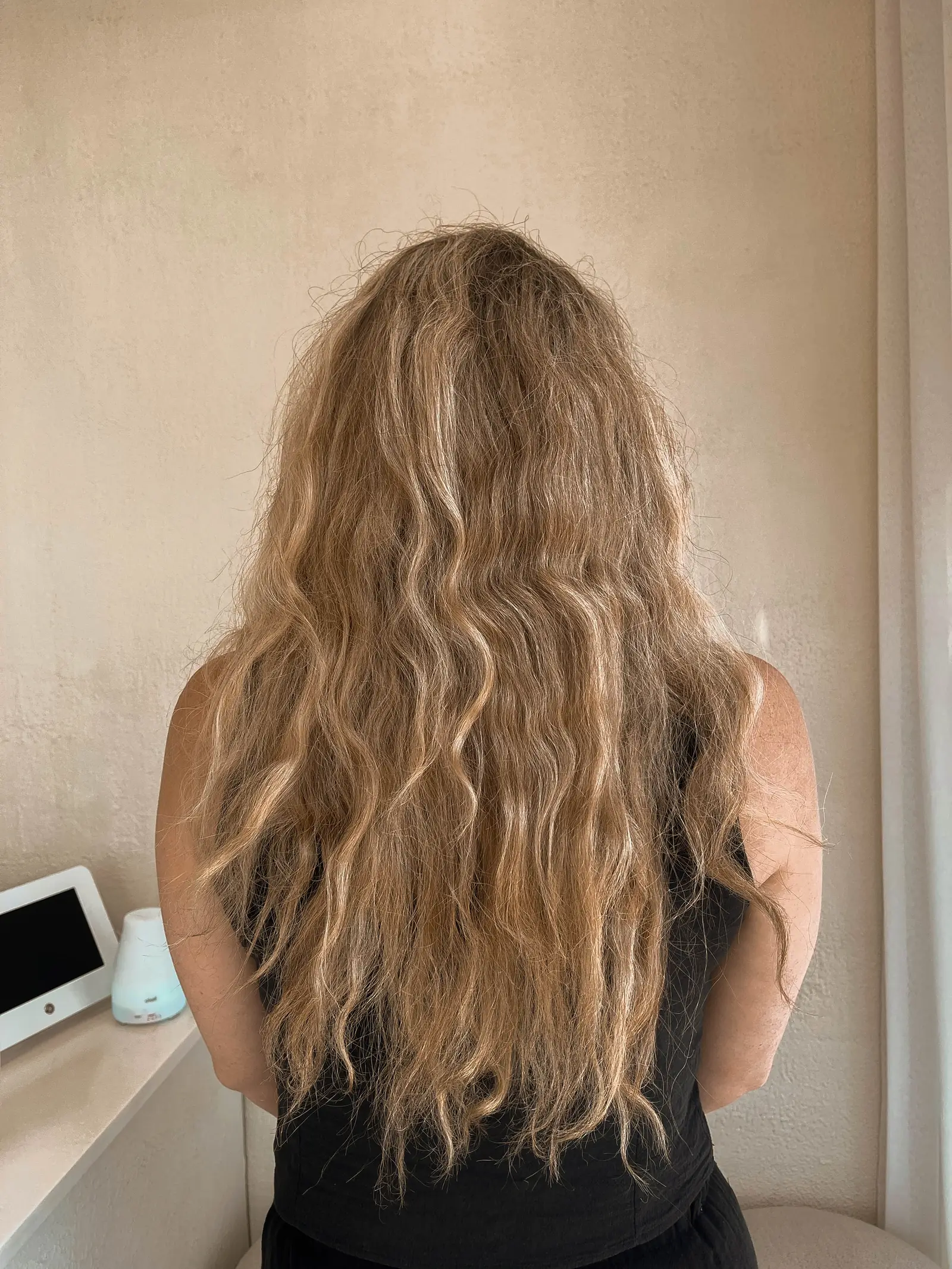 Long, frizzy, wavy hair before an Intense Hair Keratin treatment